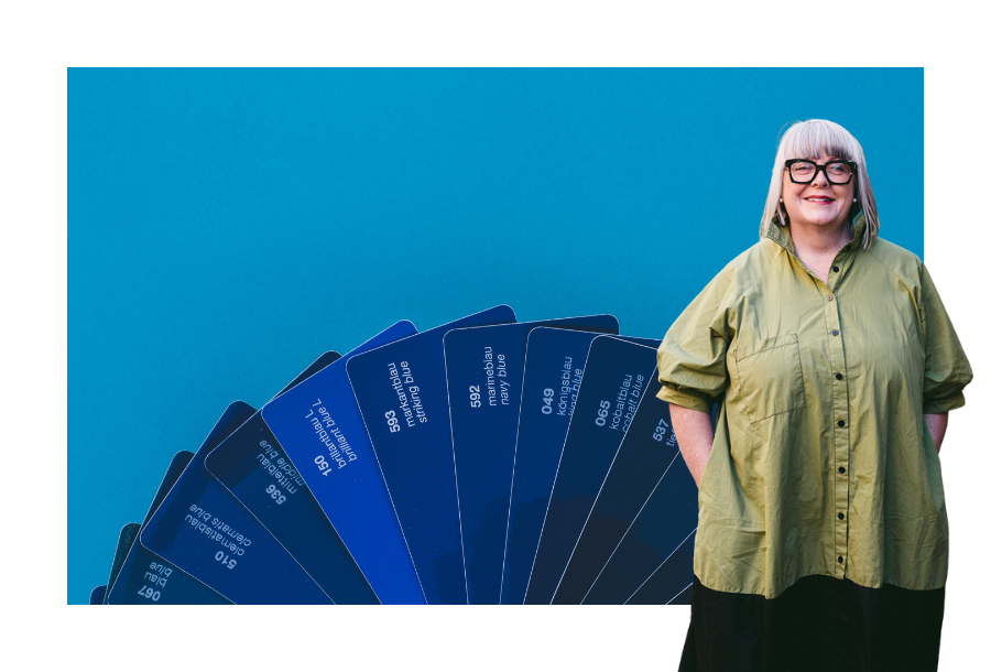 Pictured, Anthea Taylor standing in front of a dark blue panton fan spread out against a dark blue background.